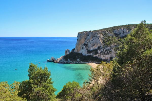 plage de Sardaigne avec une falaise et un eau turquoise